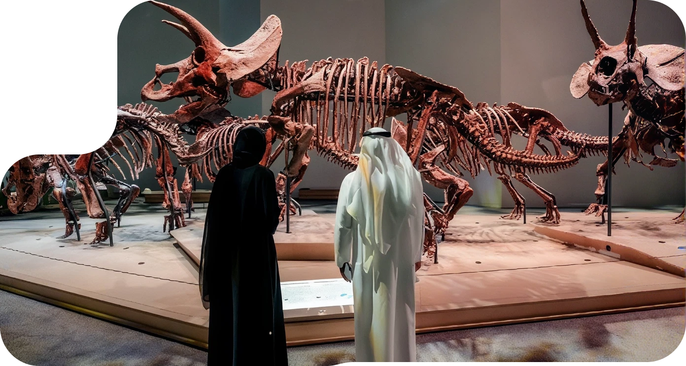 Visitors viewing a dinosaur skeleton exhibit