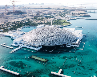 Aerial view of Louvre Abu Dhabi on the waterfront